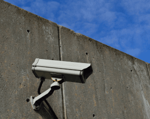 Illustration of a camera on a concrete wall.